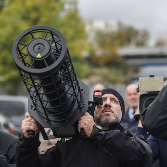Polizisten der Drohnenabwehr peilen mit einem Jammer (l) und einem Fernglas (r) bei einer Vorführung eine Drohne an. Die Polizei in Nordrhein-Westfalen hat ihre Möglichkeiten zur Drohnenabwehr vorgestellt.