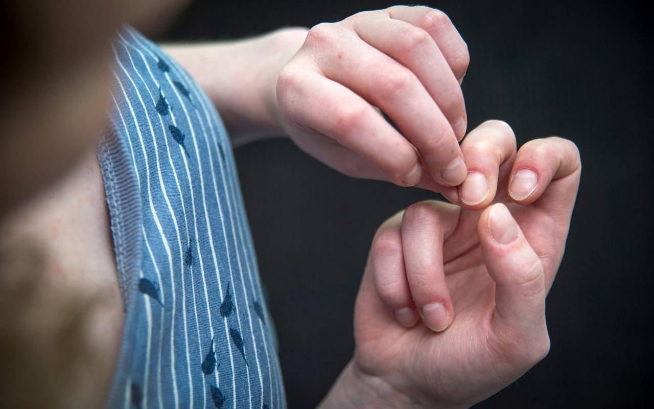 Eine Frau knibbelt an ihren Fingernägeln