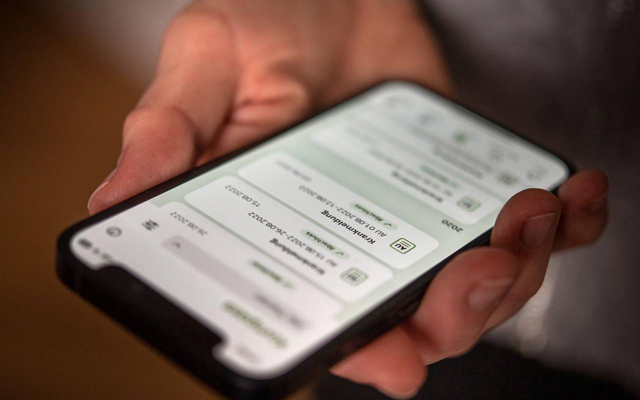 Eine elektronische AU ist auf dem Display eines Handys zu sehen