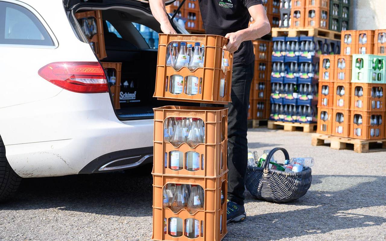 Ein Mann verlädt Mineralwasserkästen